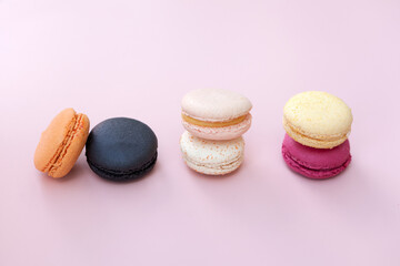 sweet meringue. Bright food photography of macroons, various macarons, from above on a vibrant pink background with crumbs and copyspace-French macaroon