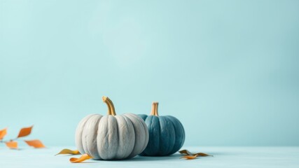 Pastel Pumpkins and Autumn Leaves on a Light Blue Background for Seasonal Design