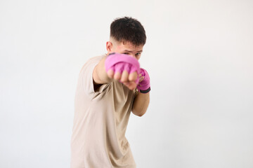European man training in boxing pink bandages