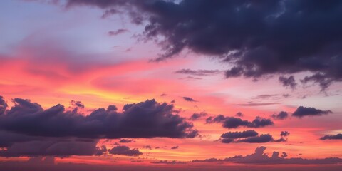 Fototapeta premium Colorful clouds swirling and shifting against a vivid pink and orange sky at sunset, horizon, weather, colors