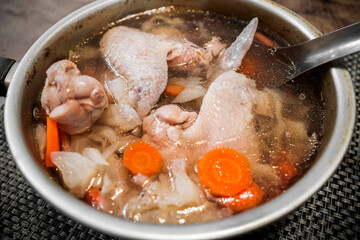 Home made chicken soup dish in sauce pan