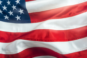 Naklejka premium Close up of American flag waving, showcasing its vibrant colors and stars. fabric flows gracefully, symbolizing patriotism and national pride