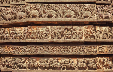 Facade of abandoned Indian temple with carved animals and patterns, India