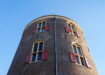 Upward view of the Drommedaris city gate tower in Enkhuizen from its base.