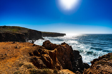 Beautiful view of cliffs, rocks, waves and blue sky on sunny day - Portugal, Algarve