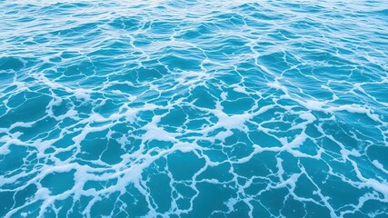Obraz premium Turquoise ocean water with foamy waves creating a tranquil and serene texture, foam, ocean, texture