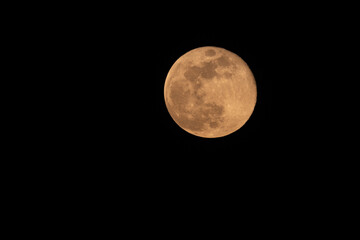 Fototapeta premium Close up of full moon on the dark night seen with the lens super