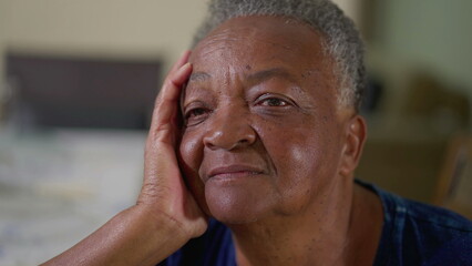 Close-up face of a pensive African American Elderly Woman Sitting at Home, Lost in Daydream