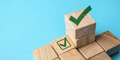 Wooden blocks stacked with green check marks on a blue background.  A visual representation of achievement, completion, and success.