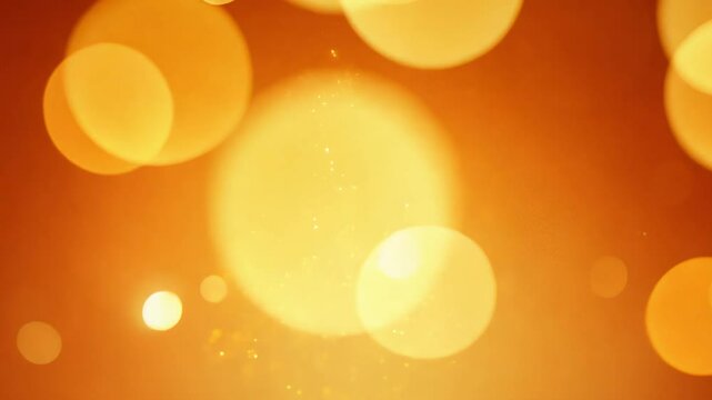 Warm orange background video with yellow bokeh lights and rising sparkles, warm and inviting
