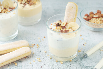 Milk mousse dessert with nuts in glasses	