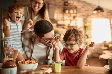 Happy family enjoying breakfast together in cozy kitchen