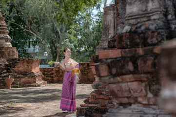 women in traditional clothing on Buddhist on background. Portrait women in traditional clothing , Thai traditional in Ayutthaya, Thailand.