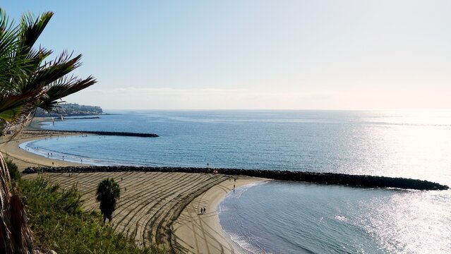 Canary Islands in winter with spring temperatures. Aerial view of Playa de Las Burras and San Agustin in Playa del Ingles in the south of Gran Canaria. Calm ocean on the horizon
