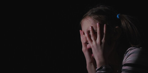 Stressed, unhappy young adolescent girl crying and feeling exhausted or depressed alone. Horizontal...