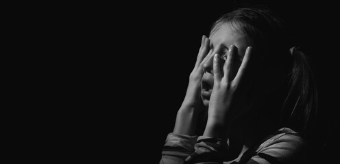 Close up unhappy young adolescent girl crying and feeling exhausted or depressed alone. Copy space...