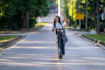 Naklejka premium A woman is riding a scooter down a street
