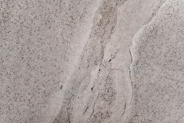 A grey stone with a white line on it