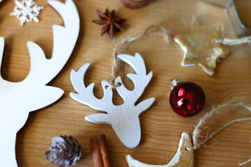 Various Christmas decorations in neutral colors on wooden background. Selective focus.