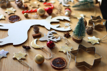 Various Christmas decorations in neutral colors on wooden background. Selective focus.