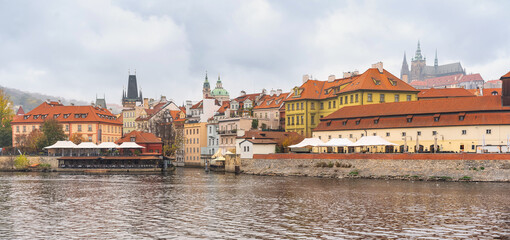 Banks of the Vltava River and view of the hill that houses monuments such as the cathedral of Prague, Czechia.