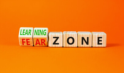 Learning or fear zone symbol. Concept words Learning zone Fear zone on wooden cubes. Beautiful orange table orange background. Business and learning or fear zone concept. Copy space.