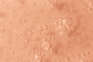 Mocha brown textured gel background with bubbles close up. Concept of cosmetic, medical and other laboratory research. Selective focus. Demonstrating color of 2025 year