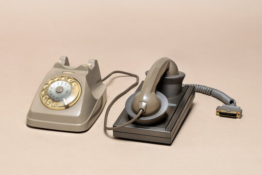 Pavia, Lombardy, Italy - October 12, 2024: Olivetti MC10 acoustic coupler and Italy SIP rotary phone at Ctrl+Alt Museum. Telco monopolist allowed only this way to connect to a network