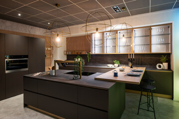 Modern brown kitchen interior design featuring island and gold fixtures