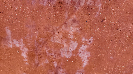 Reddish textured abstract background resembling a rusty surface, symbolizing industrial decay and ideal for Earth Day themes