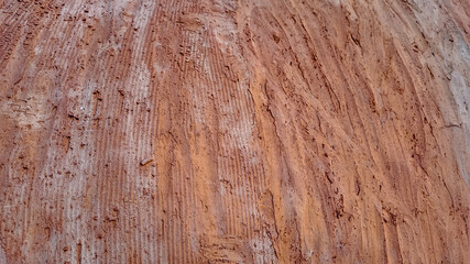 Close-up of a textured mud wall, representing sustainable construction and eco-friendly building practices in rustic settings