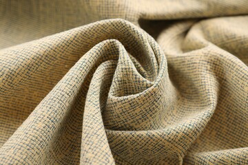 A close-up view of a textured fabric with a subtle checkered pattern