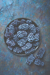 freshly frozen, blackberries on a plate, top view, no people,