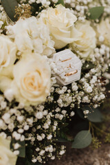 Luxurious Wedding Rings in a Velvet Ring Box Surrounded by Cream Roses, Hydrangeas, and Baby’s Breath, Perfect for Timeless Wedding Detail Photography and Floral-Inspired Wedding Decor Inspiration