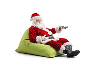 Santa Claus sitting in a beanbag and holding a remote control