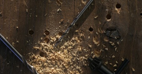 Drill Bits and Wood Shavings on a Rustic Wooden Surface