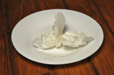 crumpled paper napkins on a white plate