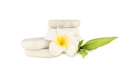 Spa stones, plumeria flower and green leaves isolated on white