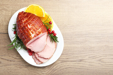 Christmas food. Tasty baked ham served on wooden table, top view and space for text