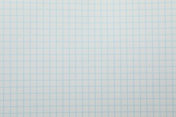 Checkered copybook sheet as background, top view. School stationery