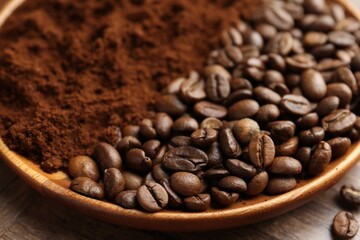 Fototapeta premium Ground coffee and roasted beans in bowl on wooden table, closeup