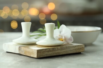 Spa stones and orchid flower on grey table, closeup