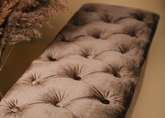 Velvet pouf with dried grass decor in a minimalist interior