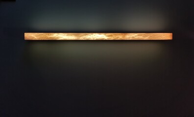 Horizontal mottled strip light against dark background