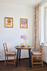 A Cozy Dining Space Featuring Beautiful Floral Decor and Vibrant Colorful Artwork