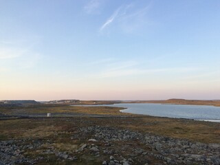 Remote mine site in northern Canada with a small lake and blue skies, near Meadowbank Mine Site, Nunavut Territory, Canada