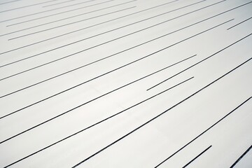 A smooth, white surface with subtle, diagonal streaks