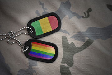 army blank, dog tag with rainbow gay pride flag and mali on the khaki texture background. military concept.