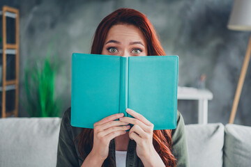 Photo of adorable sweet lady wear khaki shirt enjoying interesting book sitting sofa indoors room home house