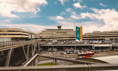 A view of Cologne Bonn Airport, featuring its modern architecture, parking areas, and a clear blue sky. Captured on September 25, 2024. Ideal for travel, transportation, and architecture themes.